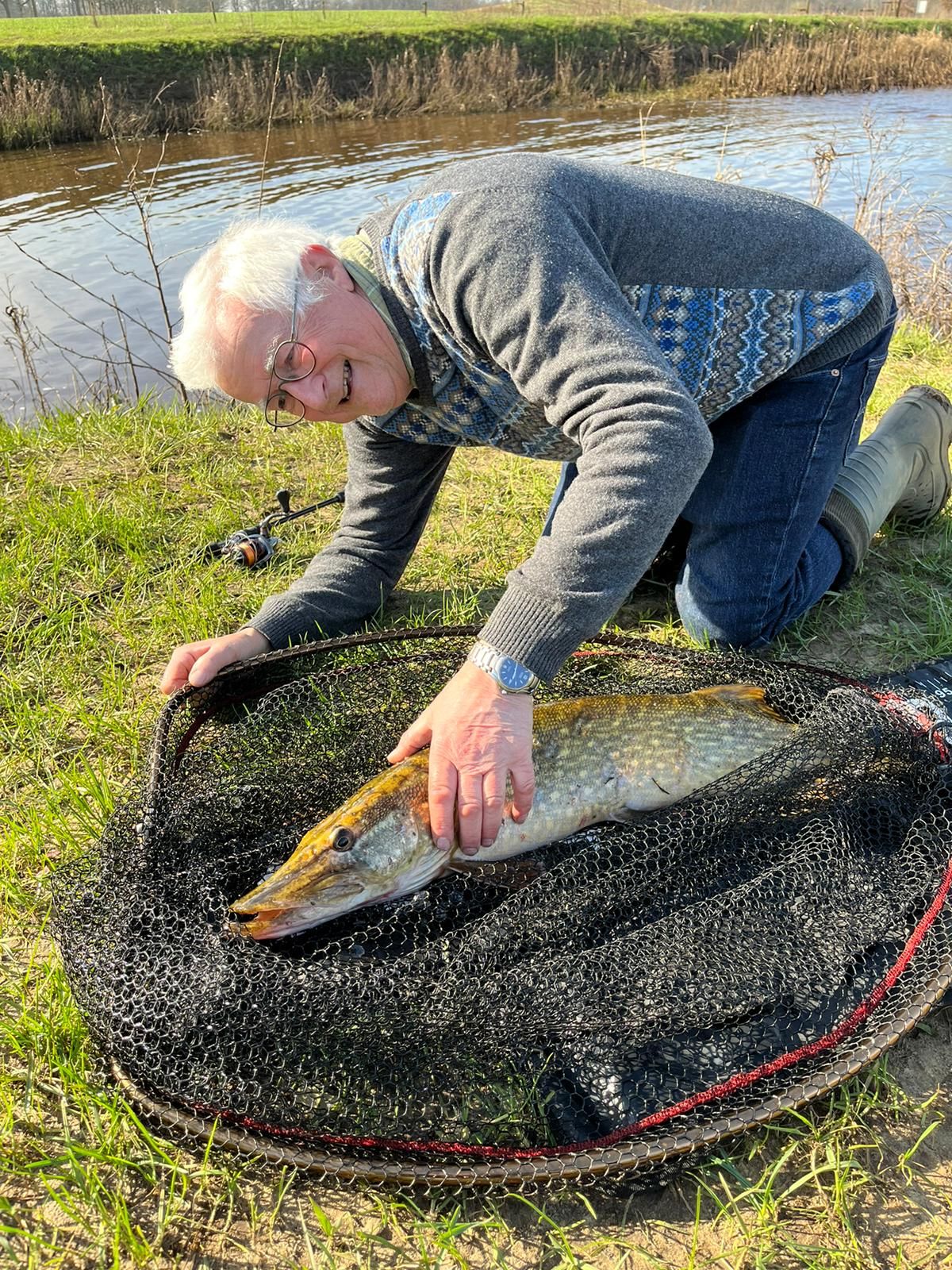 Dirk Lub holding a fish above a net